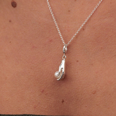 Silver hand and pearl charm