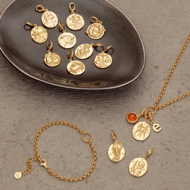 Gold Zodiac charms for the 12 star sign months with a bracelet and necklace