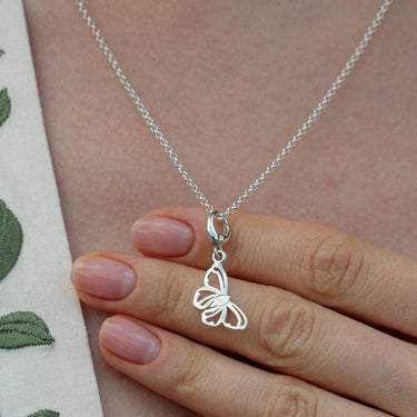 Woman Holding Silver Butterfly Charm Necklace | Butterfly-Shaped Pendant