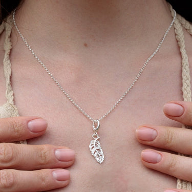Woman Wearing Silver Feather Charm Necklace | Feather Pendant Necklace