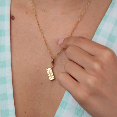 Woman Wearing Gold Bourbon Biscuit Charm Necklace | Biscuit Pendant Necklace