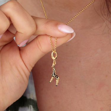 Woman Holding Gold Giraffe Charm Necklace | Animal Pendant Necklace