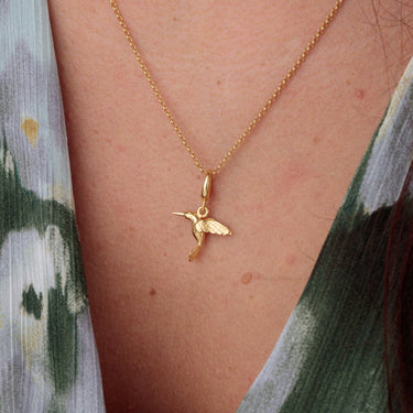 Woman Wearing Gold Hummingbird Charm Necklace | Bird Pendant Necklace