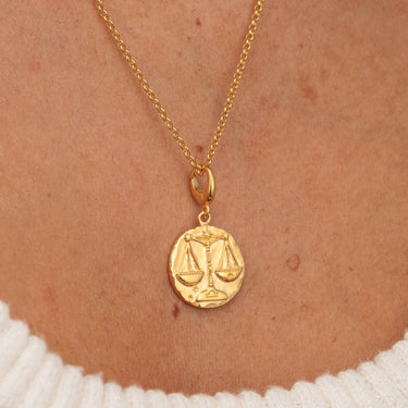 Gold Libra zodiac charm necklace on model