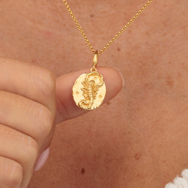Gold Scorpio Charm Zodiac necklace in hands