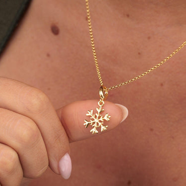 Woman Wearing Gold Snowflake Charm Necklace | Christmas & Winter Pendant Necklace