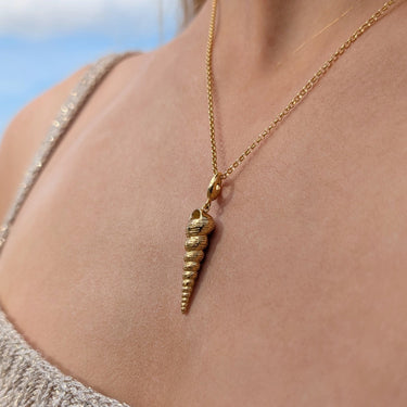 Woman Wearing Gold Spire Shell Charm Necklace | Shell Pendant Necklace