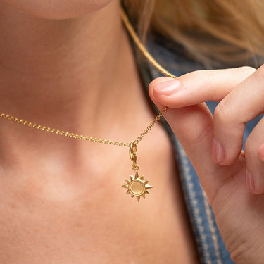 Woman Wearing Gold Sunshine Charm Necklace | Sun Pendant Necklace