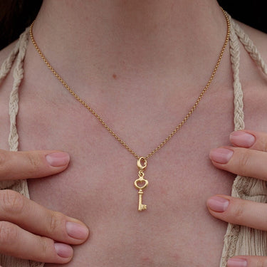 Woman Wearing Gold Key Charm Necklace | Heart & Key Pendant