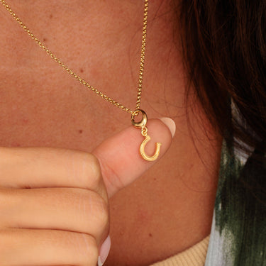 Gold Lucky Horseshoe Charm Necklace Worn by Women & Held in Hand