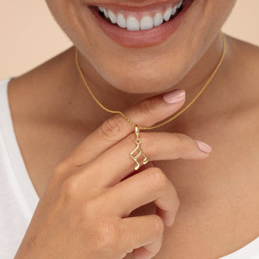 Woman Wearing Gold Music Note Charm Necklace | Semiquaver Music Pendant
