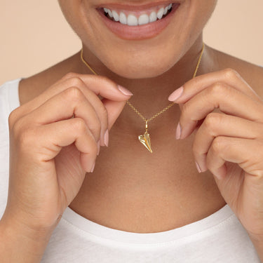 Woman Holding Gold Paper Plane Charm Necklace | First Anniversary Pendant Necklace