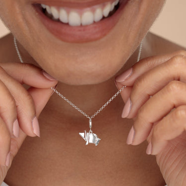 Woman Holding Silver Origami Pig Charm Necklace | Pig Pendant Necklace