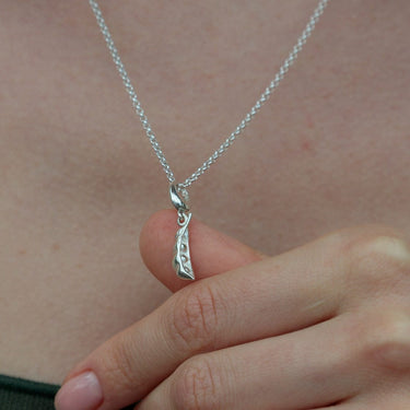 Silver Peapod Charm Necklace held in hands | Peas in a Pod Pendant Necklace