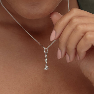 Woman Holding Silver Chess Piece Charm Necklace | Queen Chess Piece Pendant