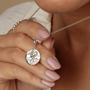 Silver Aquarius Charm pendant on silver Necklace showing detailed motif.