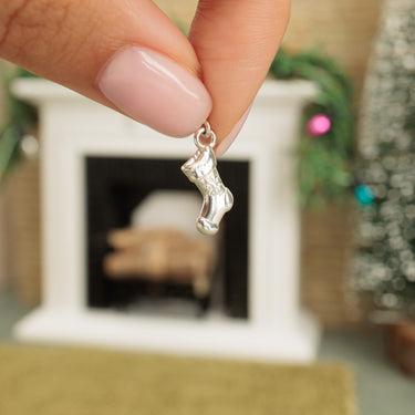 Silver Christmas Stocking Charm Held in Hands