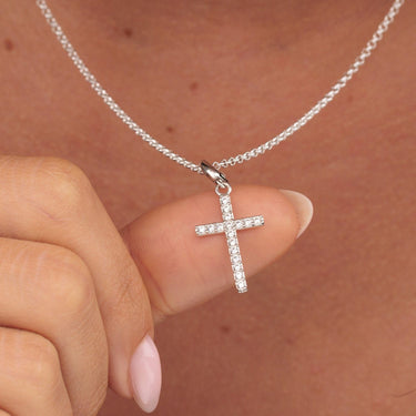 Woman Holding Silver Sparkling Cross Charm Necklace | Clear Stone Cross Pendant
