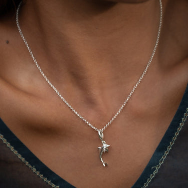 Woman Wearing Silver Dolphin Charm Necklace | Jumping Dolphin Pendant