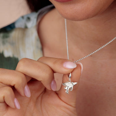Woman Holding Silver Flying Pig Charm Necklace | Animal Pendant Necklace