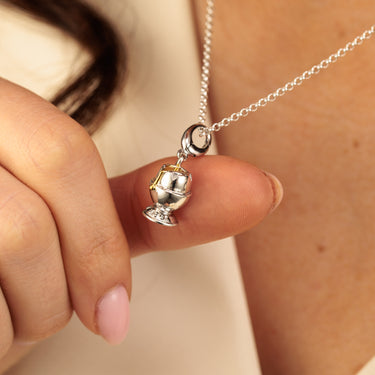 Woman Holding Sterling Silver Runny Egg and Egg Cup Charm Necklace with an 18ct Gold Yolk Centre