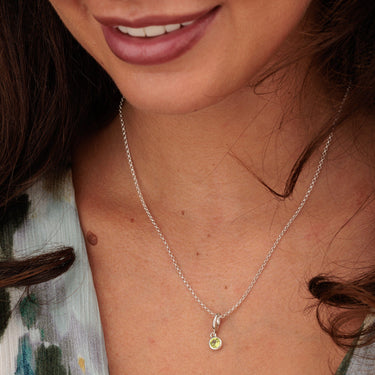 Woman Wearing August Birthstone Charm Necklace | Peridot Gemstone Pendant