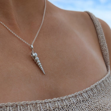 Woman Wearing Silver Spire Shell Charm Necklace | Shell Pendant Necklace
