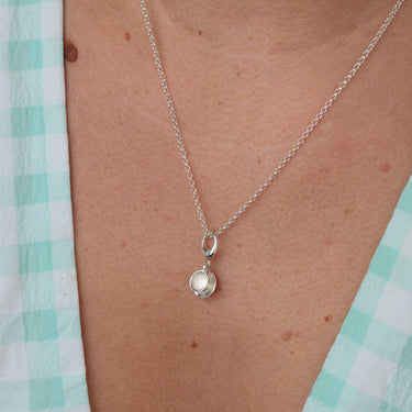 Woman Wearing Silver Teacup Charm Necklace | Cup and Saucer Pendant