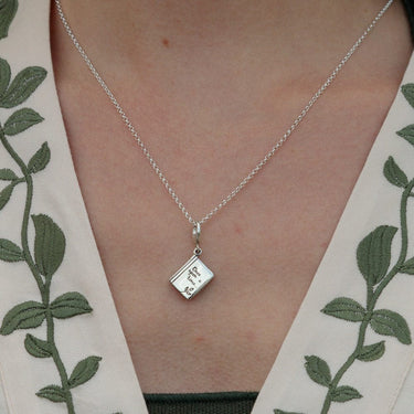 Woman Wearing Silver Story Book Charm Necklace | Book Pendant Necklace