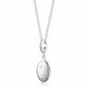 A sterling silver oval locket necklace with a celestial design, attached to a belcher chain.