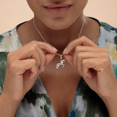 Woman Holding Silver Unicorn Charm Necklace | Unicorn Pendant