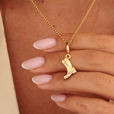 Gold Wellington Charm Necklace Held in Model's Hands